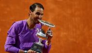 Spain's Rafael Nadal celebrates with the trophy after winning his final match against Serbia's Novak Djokovic... Reuters/Guglielmo Mangiapane 