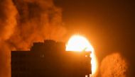 Smoke and flames rise above a building during Israeli air strikes, amid a flare-up of Israeli-Palestinian violence, in Gaza City May 17, 2021. REUTERS/Ibraheem Abu Mustafa