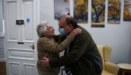 Stephen Crowe hugs is mother Susan Crowe, 96, who is a resident at Alexander House Care Home in Wimbledon, as coronavirus disease (COVID-19) restrictions continue to ease, London, Britain, May 17, 2021. REUTERS/Hannah McKay