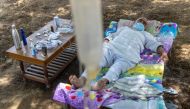 Harveer Singh, 65, a villager suffering from COVID-19 rests in a cot as he receives treatment at a makeshift open-air clinic, amidst the spread of the coronavirus disease (COVID-19), in Mewla Gopalgarh village, in Jewar district, in the northern state of 