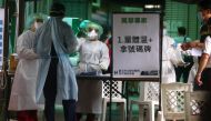 A healthcare frontline worker prepares people to get their rapid test following a surge of coronavirus disease (COVID-19) infections in Taipei, Taiwan May 17, 2021. REUTERS/Ann Wang