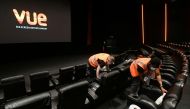 Staff members clean seats at Vue Cinema in Leicester Square during its reopening, as coronavirus disease (COVID-19) restrictions continue to ease in London, Britain, May 17, 2021. REUTERS/Toby Melville