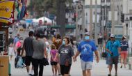 FILE PHOTO: People wearing face masks walk along the ocean pier in Huntington Beach, California, U.S., July 23, 2020. REUTERS/Mike... MIKE BLAKE July 28, 2020
