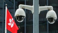 A Hong Kong flag is flown behind a pair of surveillance cameras outside the Central Government Offices in Hong Kong, China July 20, 2020. Reuters/Tyrone Siu