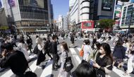 Passersby wearing protective face masks walk on Shibuya crossing amid the coronavirus disease (COVID-19) outbreak in Tokyo, Japan April 23, 2021, in this photo taken by Kyodo.
