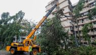 A crane lifts a fallen tree after strong winds caused by Cyclone Tauktae, in Mumbai, India, May 18, 2021. REUTERS/Francis Mascarenhas