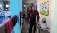 Palestinian man Ihab El-Attar, who, according to him, lost four members of his family when an Israeli strike hit their house and injured him, walks with crutches at a United Nations-run school where he takes refuge, in Gaza City May 18, 2021. REUTERS/Suha