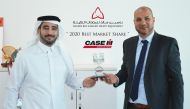 Eyad Rashid (right), General Manager at NBK Heavy Equipment, with an official in Doha.