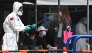 A soldier disinfects a person who is leaving a coronavirus disease (COVID-19) testing site following a surge of coronavirus disease (COVID-19) infections in Taipei, Taiwan May 19, 2021. Reuters/Ann Wang