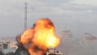 Smoke and flames are seen following an Israeli air strike on a building, amid a flare-up of Israeli-Palestinian fighting, in Gaza City May 18, 2021. REUTERS/Mohammed Salem