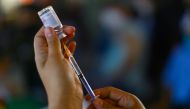 A health worker prepares to vaccinate a school worker with a dose of China's CanSino COVID-19 vaccine during a mass vaccination for teachers and school staff against coronavirus disease in Mexico City, Mexico May 18, 2021. REUTERS/Edgard Garrido
