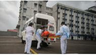 Members of the Indian Navy transport a person to receive medical attention after a rescue from a sunken barge in the Arabian Sea in the aftermath of cyclone Tauktae's landfall, at naval air station INS Shikra in Mumbai, May 18, 2021. Indian Navy/Handout v