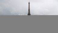 A man poses on a giant artwork by French artist JR installed on the Trocadero square in front of the Eiffel Tower in Paris, France, May 19, 2021. REUTERS/Sarah Meyssonnier NO RESALES. NO ARCHIVES TPX IMAGES OF THE DAY
