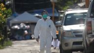 A healthcare worker walks near a workers' dormitory where more than a thousand COVID-19 cases were detected, in Bangkok, Thailand May 22, 2021. REUTERS/Soe Zeya Tun