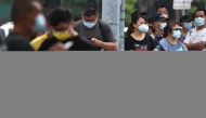 People wearing protective face masks wait to get their rapid test following a surge of coronavirus disease (COVID-19) infections in Taipei, Taiwan, May 19, 2021. REUTERS/Ann Wang
