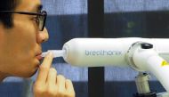 File photo: A staff member demonstrates the usage of Breathonix breathalyzer test kit developed by Breathonix, a start-up by the National University of Singapore, able to detect the coronavirus disease (COVID-19) within a minute according to the company, 