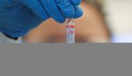An employee holds a vial containing Sputnik V vaccine against the coronavirus disease (COVID-19) made with ingredients and technology supplied by Russia at Brazilian pharmaceutical company Uniao Quimica in Guarulhos, Brazil May 20, 2021. REUTERS/Amanda Pe