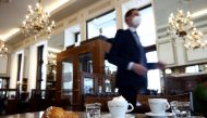 Coffee and a pastry are seen on a table inside Cafe Mozart, as the country eases its coronavirus disease (COVID-19) restrictions, in Vienna, Austria, May 19, 2021. Reuters/Lisi Niesner