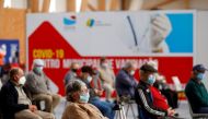 FILE PHOTO: People wait in a COVID-19 vaccination centre in Seixal, Portugal, March 22, 2021. REUTERS/Pedro Nunes/File Photo
