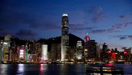 A boat crosses Victoria Harbour in front of a skyline of buildings during sunset. Hong Kong. Reuters/Tyrone Siu/File Photo
