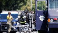 San Jose Bomb Squad technician prepares to enter the scene of the Santa Clara Valley Transportation Authority mass shooting suspects house that was set ablaze in San Jose, California, U.S. May 26, 2021. REUTERS/Peter DaSilva
