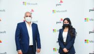 Officials of Microsoft and PwC pose for a photo.