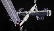 A child stands near a giant screen showing the images of the Tianhe space station at an exhibition featuring the development of China's space exploration on the country's Space Day at China Science and Technology Museum in Beijing. (Reuters/File Photo)