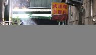 Soldiers in protective suits disinfect a street following the recent surge of coronavirus disease (COVID-19) infections, in Tucheng district of New Taipei City, Taiwan May 27, 2021. REUTERS/Ann Wang
