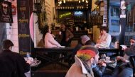 FILE PHOTO: People sit at a cafe that reopened after the coronavirus disease (COVID-19) restrictions were eased, in Istanbul, Turkey March 2, 2021. REUTERS/Cansu Alkaya


