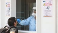 A medical worker conducts a rapid test for coronavirus disease (COVID-19) on a Taiwanese resident following an increasing number of locally transmitted cases at Songshan Airport in Taipei, Taiwan, June 2, 2021. REUTERS/Ann Wang