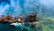 Smoke rises from a fire onboard the MV X-Press Pearl vessel as it sinks while being towed into deep sea off the Colombo Harbour, in Sri Lanka June 2, 2021. Sri Lanka Airforce Media/Handout via REUTERS 