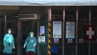 Taiwan's health minister said on Thursday it was still too early to talk about needing to raise the alert level and go into a full lockdown, but the spike in COVID-19 infections on island gave him no reason for optimism.