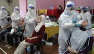 Medical workers collect swab samples from people to be tested for the coronavirus disease (COVID-19) in Cyberjaya, Malaysia, June 2, 2021. REUTERS/Lim Huey Teng
