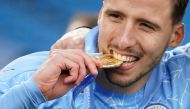 Manchester City's Ruben Dias celebrates with his medal after winning the Premier League Pool via REUTERS/Dave Thompson 