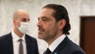 FILE PHOTO: Prime Minister-designate Saad al-Hariri walks by after meeting with Lebanon's President Michel Aoun at the presidential palace in Baabda, Lebanon March 22, 2021. REUTERS/Mohamed Azakir/File Photo