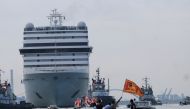 Venice residents ride on a boat as they protest to demand an end to cruise ships passing through the lagoon city, as the first cruise ship of the summer season departs from the Port of Venice, Italy, June 5, 2021. REUTERS/Manuel Silvestri