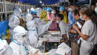 A medical worker collects a swab from a resident during a mass testing for the coronavirus disease (COVID-19) at a makeshift testing site in Guangzhou, Guangdong province, China May 30, 2021. Picture taken May 30, 2021. cnsphoto via REUTERS