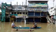 Men float along a flooded road during a COVID-19 curfew in Biyagama, near Colombo, Sri Lanka June 6, 2021. REUTERS/Dinuka Liyanawatte