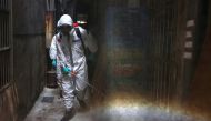 Soldiers in protective suits disinfect a street following the recent surge of coronavirus disease (COVID-19) infections, in the Tucheng district of New Taipei City, Taiwan May 27, 2021. REUTERS/Ann Wang/File Photo