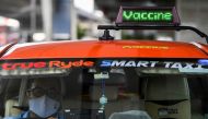 Thai taxi driver Sombat Subin rides with a sign above his cab showing that he has been vaccinated against the coronavirus disease (COVID-19) in order to attract more customers in Bangkok, Thailand, May 29, 2021. Picture taken May 29, 2021. REUTERS/Chaline