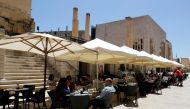 People sit at an outdoor restaurant as restaurants and markets reopened for business after coronavirus disease (COVID-19) vaccinations reached 60% of the adult population, in Valletta, Malta May 10, 2021. REUTERS/Darrin Zammit Lupi/File Photo