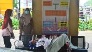 A patient lies on a bench while queuing to be treated at the emergency ward of the government's hospital Dr. Loekmono Hadi, amid the coronavirus disease (COVID-19) pandemic in Kudus, Central Java province, Indonesia, June 2, 2021. Picture taken June 2, 20