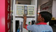File photo: A fuel pump attendant cleans the keypad of a pump at an Indian Oil filling station in Ahmedabad, India, May 14, 2018. Reuters/Amit Dave/File Photo