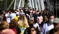 People walk across the Golden Jubilee Bridge during sunny weather, amid the coronavirus disease (COVID-19) outbreak, in London, Britain, June 5, 2021. REUTERS/Henry Nicholls
