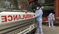 Health workers wear personal protective equipment (PPE) as they prepare to carry the body of a person, who died from complications related to the coronavirus disease (COVID-19), for cremation at a crematorium in New Delhi, India, June 10, 2021. REUTERS/Da