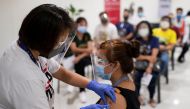 A health worker administers a dose of the Russian Sputnik V COVID-19 vaccine, as economic workers queue to get vaccinated at Robinsons Place, in Manila, Philippines, June 8, 2021. REUTERS/Eloisa Lopez