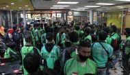 Food delivery drivers crowd in a McDonald's restaurant and wait for BTS meal orders in Bogor, Indonesia, June 9, 2021 in this picture obtained from social media. SOFYAN SHAH ? RADAR BOGOR/via REUTERS