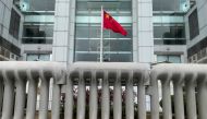 Chinese national flag is seen behind water-filled barriers outside the Chinese Liaison Office, in Hong Kong, China June 12, 2021. Reuters/Tyrone Siu