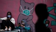 People wearing protective masks sit as they wait for their turn to receive vaccine in Jakarta, Indonesia June 11, 2021. Antara Foto/Sigid Kurniawan via Reuters

