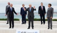 U.S. President Joe Biden and British Prime Minister Boris Johnson gesture as they pose for a family photo with G-7 leaders; European Council President Charles Michel, Japan's Prime Minister Yoshihide Suga, Italy's Prime Minister Mario Draghi and French Pr